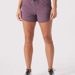 A woman wearing purple shorts and black shoes.