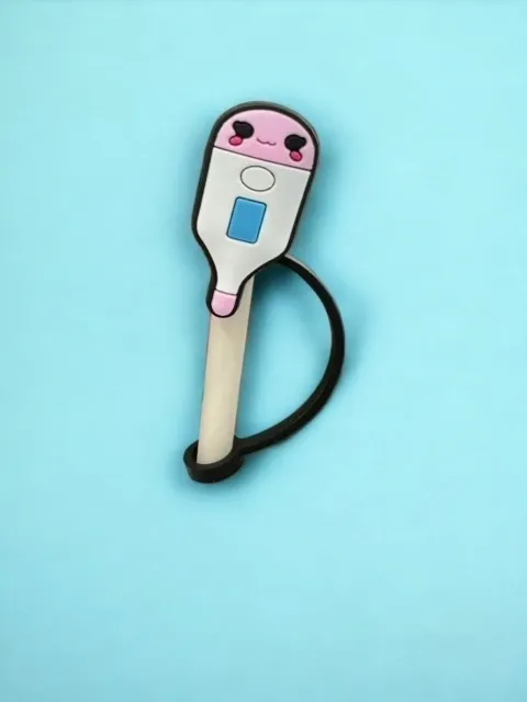 A pink and white toothbrush on top of a blue background.