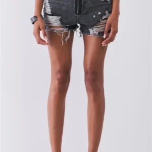 A person wearing shorts with holes and metal plates on them.