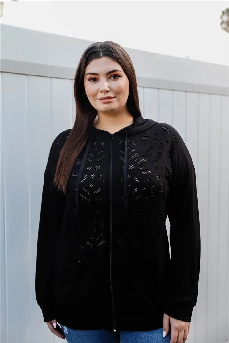 A woman wearing black and standing outside.