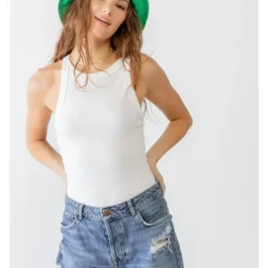 A woman wearing a green hat and white shirt