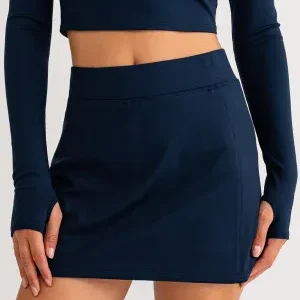 A woman wearing a black skirt and top.