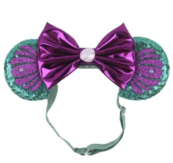 Purple bow headband with seashell ears.