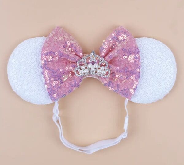 Pink sequined headband with crown and ears.