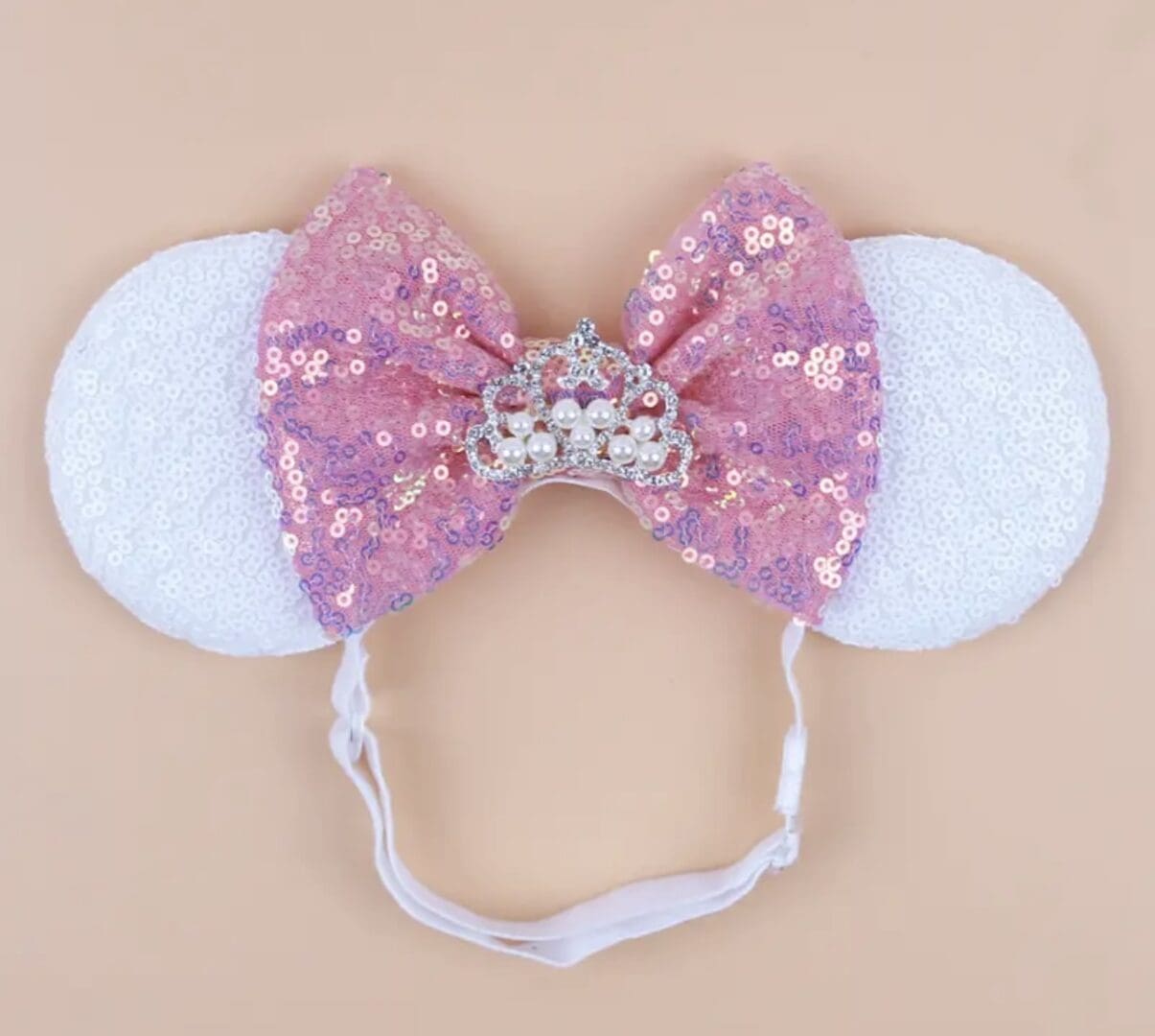 Pink sequined headband with crown and ears.