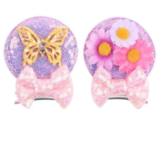 Two sparkly hair clips with bows and flowers.