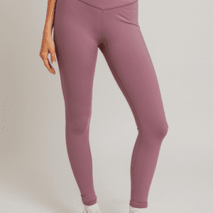 Woman wearing mauve leggings and white sneakers.