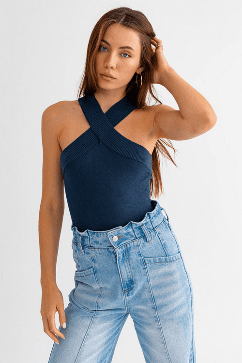 Woman in blue halter top and jeans.