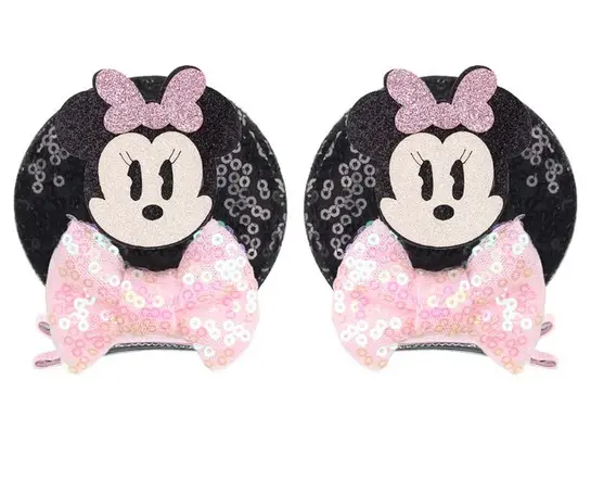 Two black and pink Minnie Mouse hair clips.