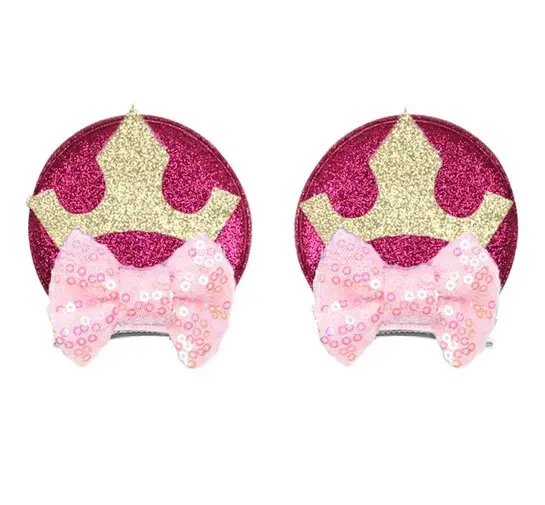 Two princess crown hair clips with bows.