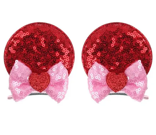 Red sequin hair clips with bows and hearts.